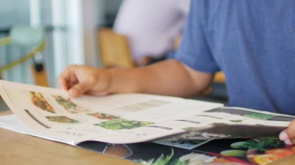 Human hands open a menu at restaurant 4K(UHD)